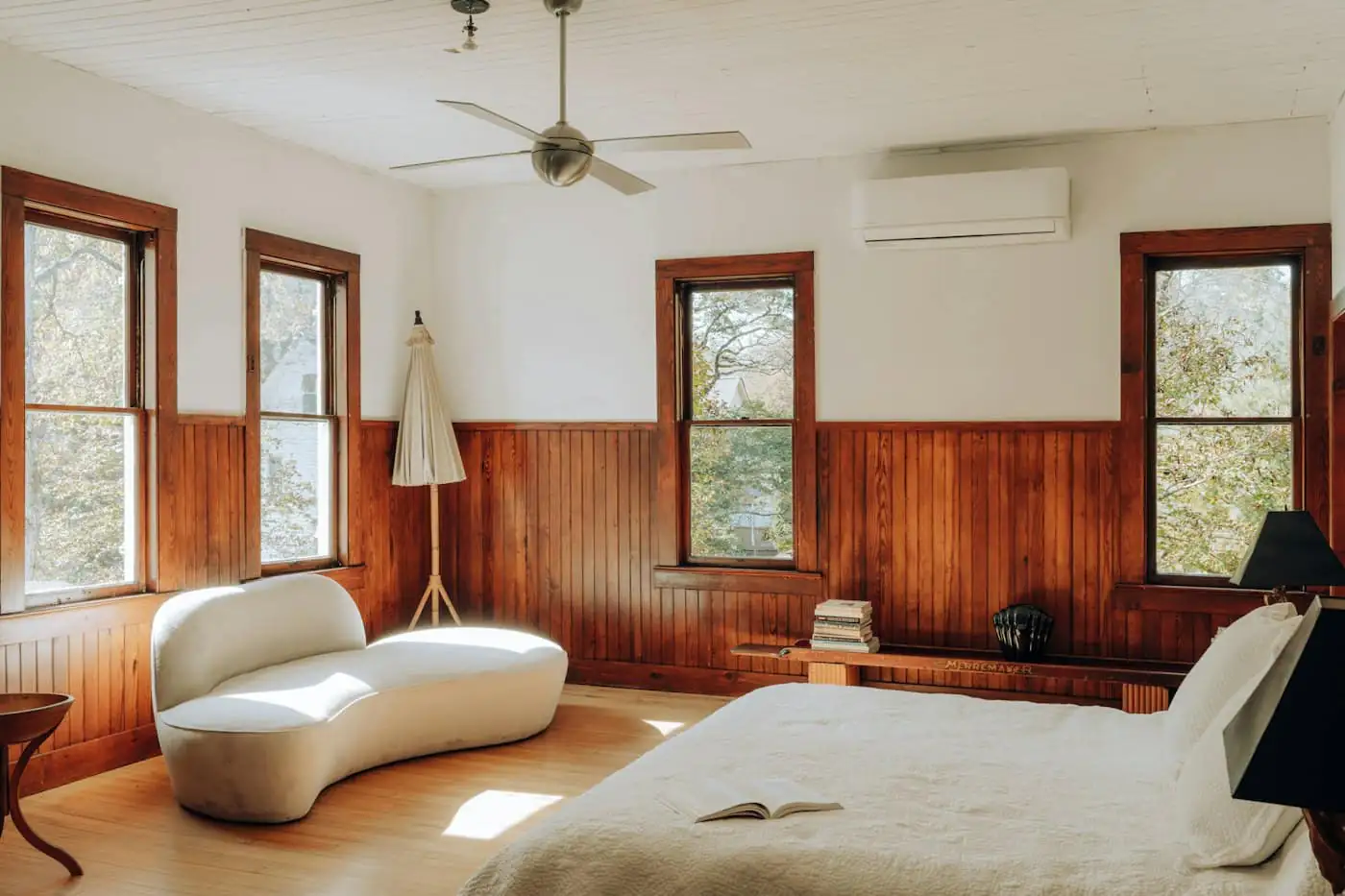 Main bedroom with timber floor and large windows