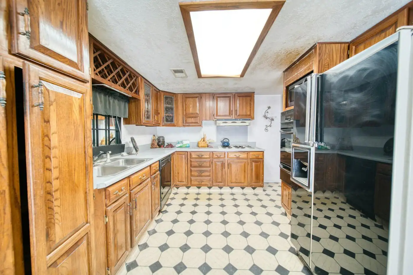 Original cramped kitchen with old cabinets and a dividing wall