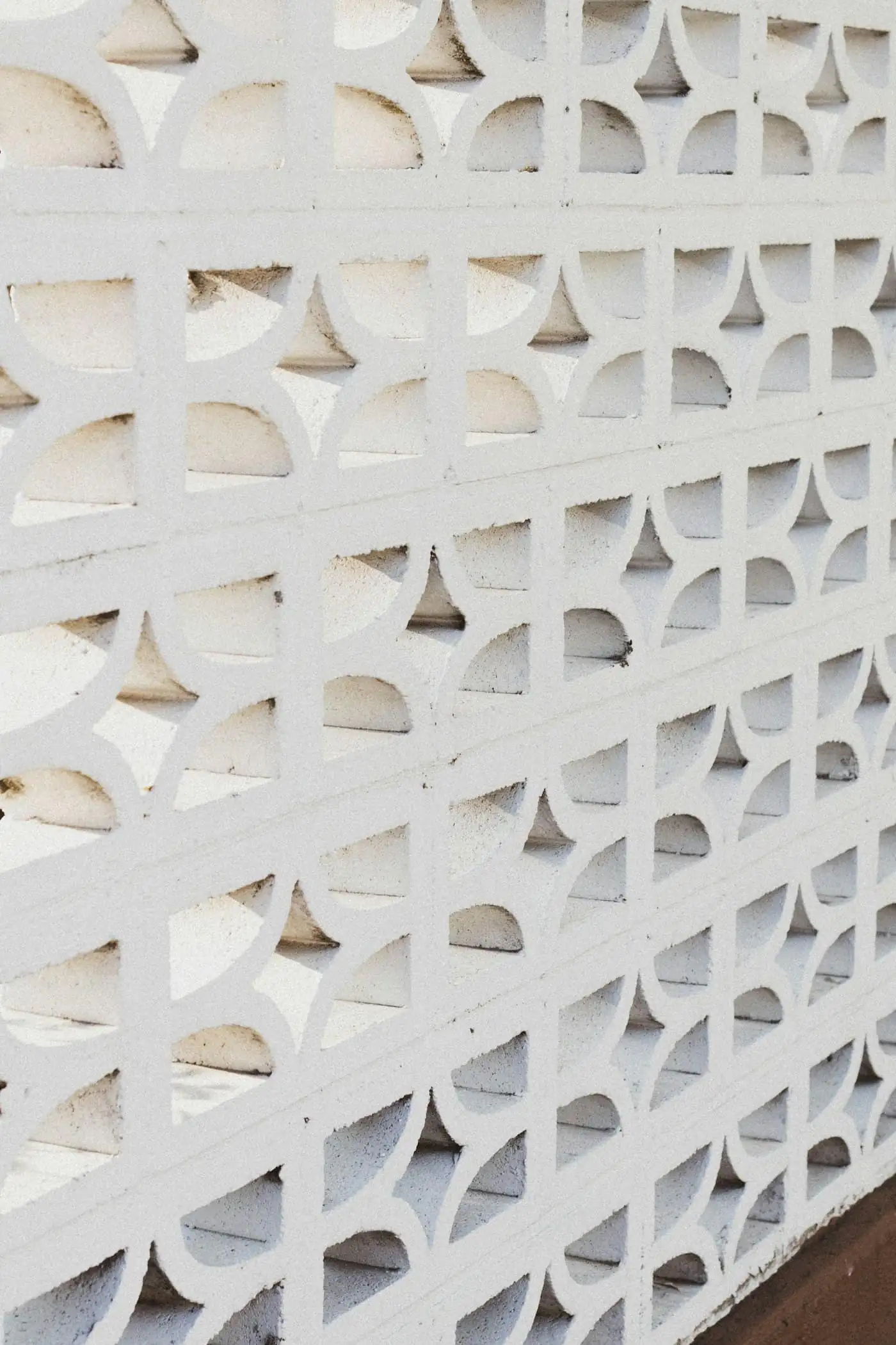 Restored breeze-block wall casting patterned shadows