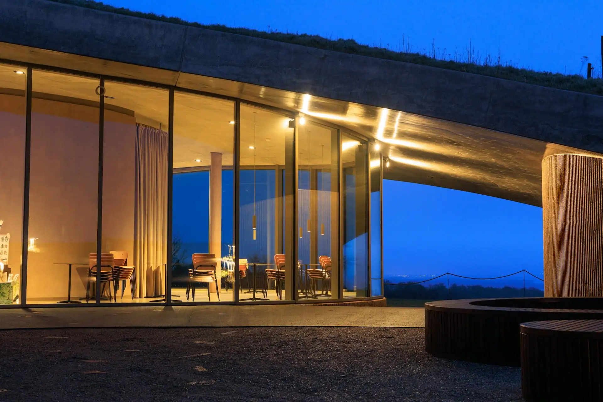 Modern rear extension with full-width sliding glass doors at dusk
