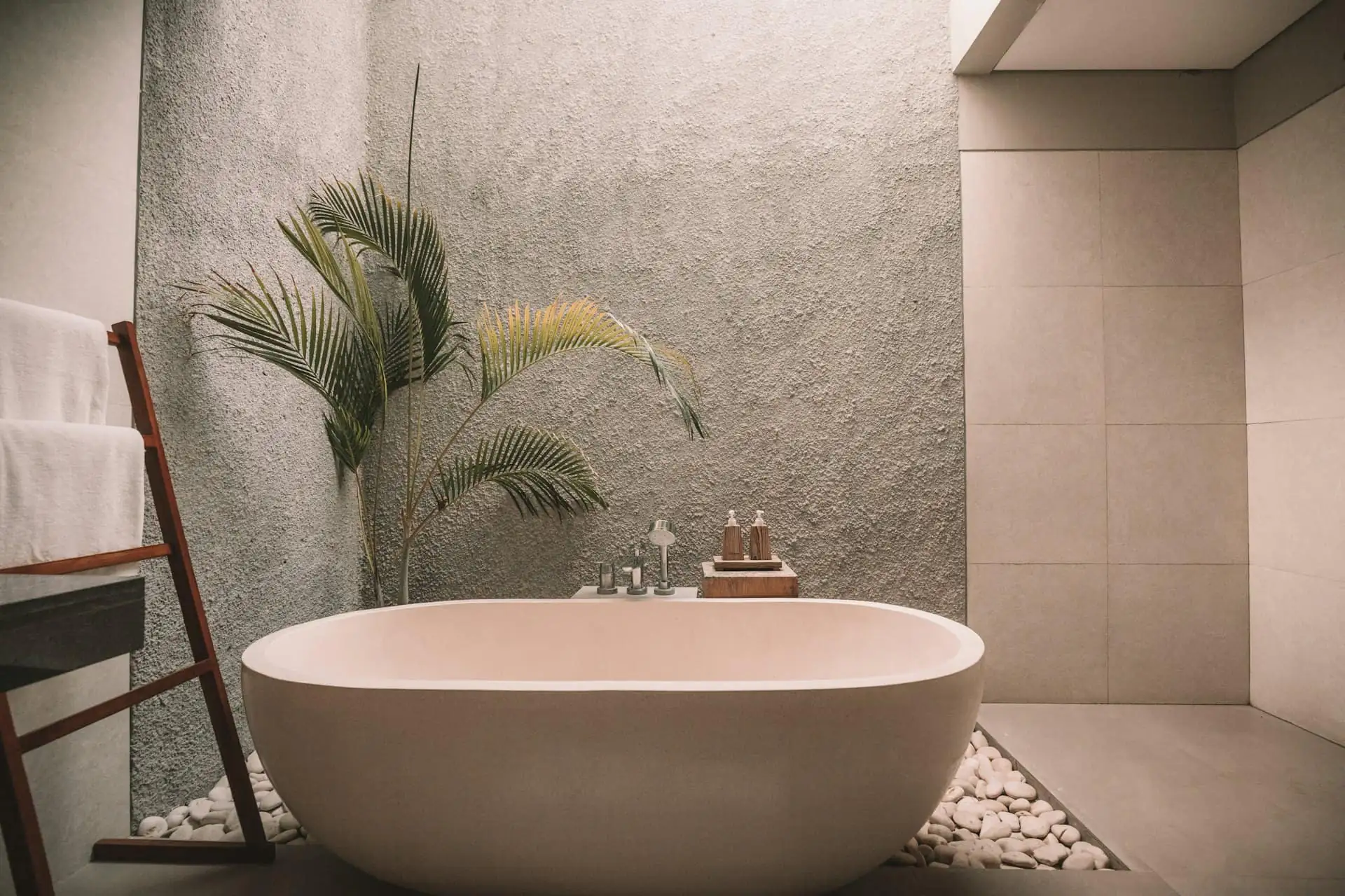 Hotel-style bathroom with freestanding bath and stone-look tiles
