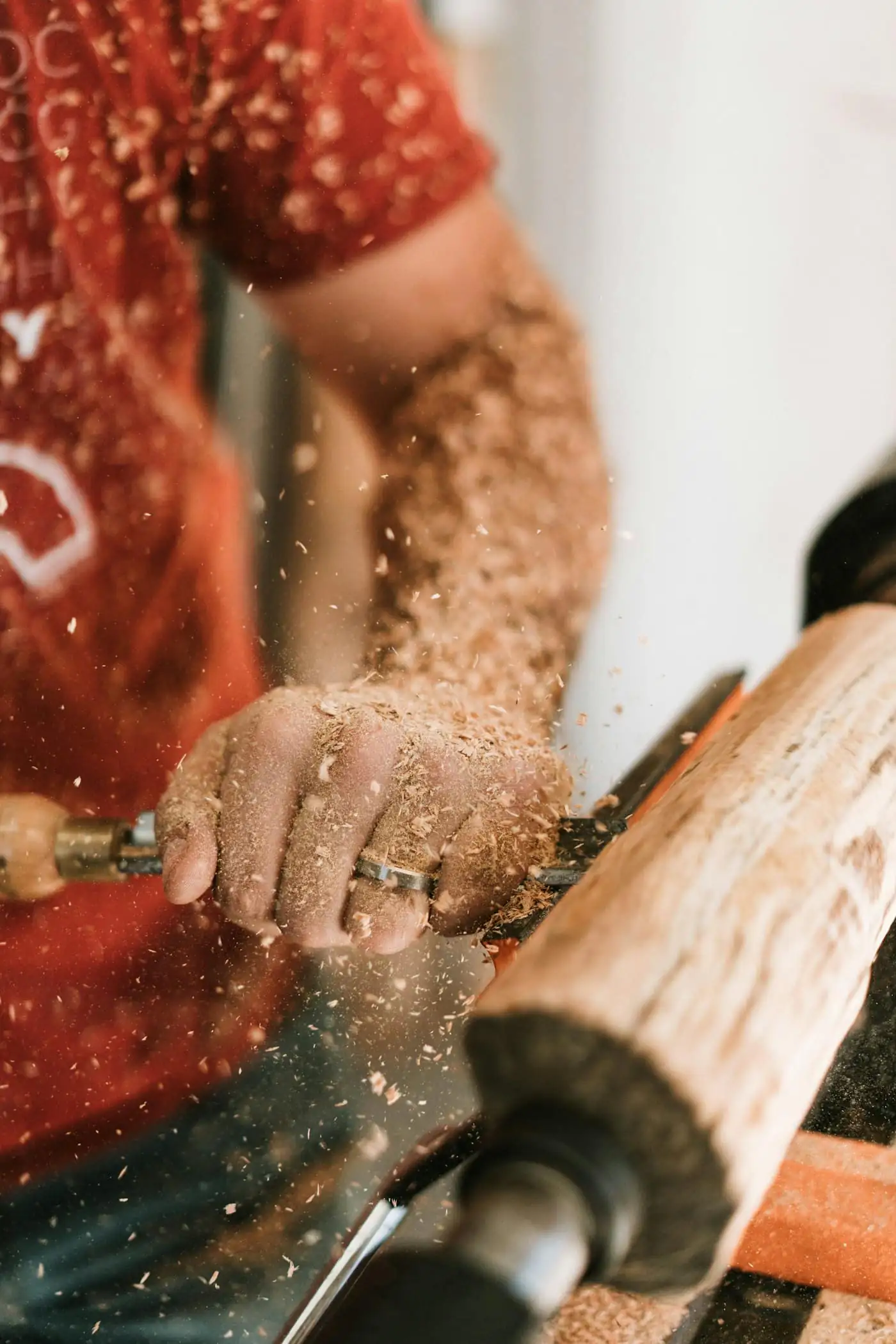 A carpenter’s hands finishing timber in our workshop