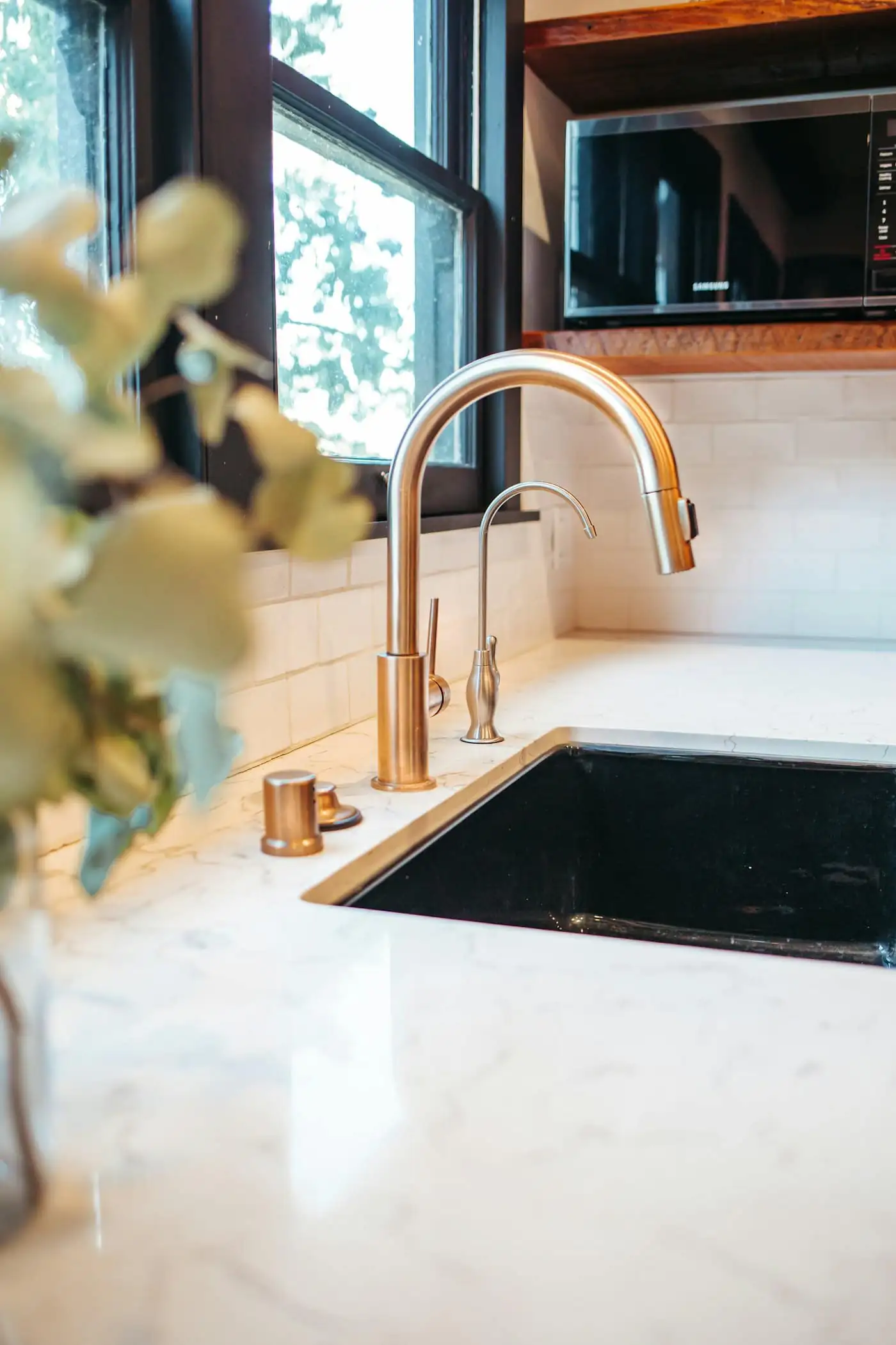 Close-up of quartz worktop edge and brushed brass tap